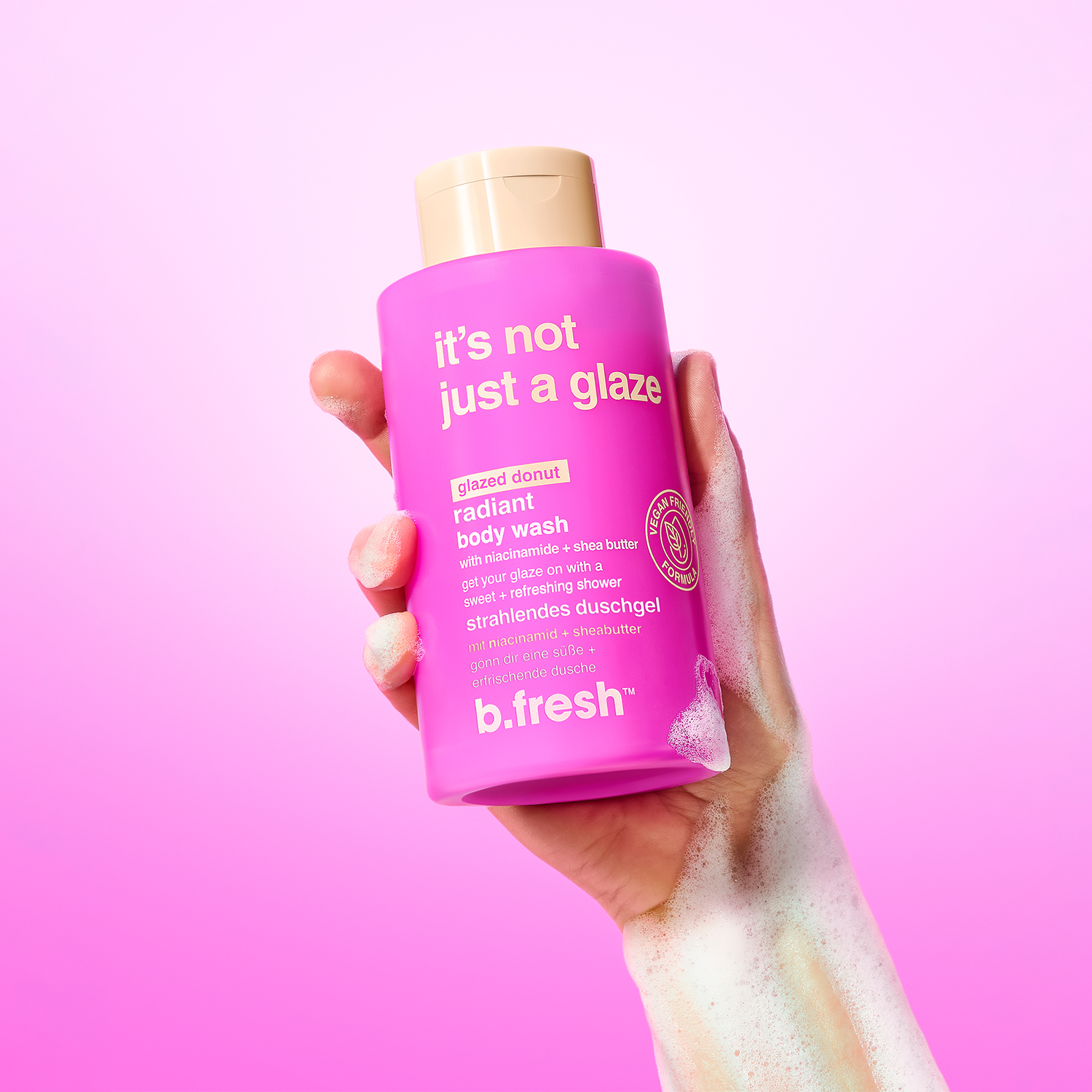 hand holding a bottle of it's not just a glaze body wash